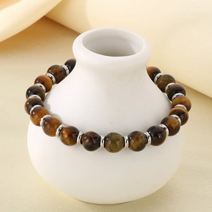 Detailed close-up of tiger eye stone beads and silver metal spacers on elastic bracelet