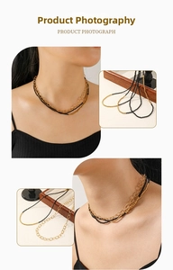 Detail of layered gold titanium necklace with black spinel beads on a wooden tray