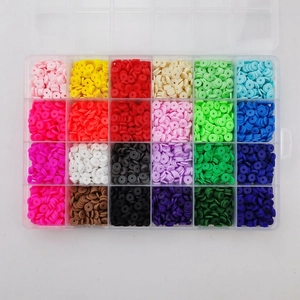 Overhead view of 24-color polymer clay heishi beads organized in a plastic storage box