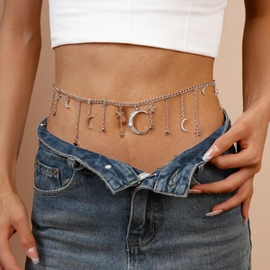Silver celestial waist chain with star moon charms and pearls over denim jeans