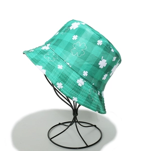 Detail of green checkerboard pattern bucket hat with St. Patrick's Day clover print