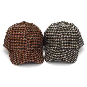 Classic plaid tweed baseball caps in orange and beige with houndstooth texture