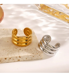Detail of triple-ribbed stackable wide open rings in polished gold and silver finishes