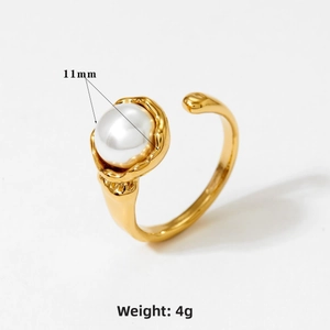 Detail of a gold lava texture open ring featuring an 11mm white pearl center