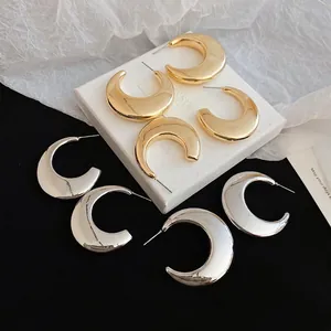 Polished C-shape thick metal hoop earrings in gold and silver finish with studs