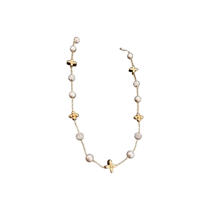 Gold plated necklace with clover charms and white pearls on a clean white background
