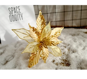 Macro detail of golden glitter artificial Christmas flower with mesh petals on snow