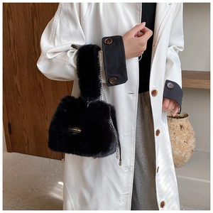 Detail of plush black bucket bag with silver chain strap and love every day text label