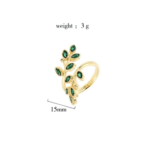 Detailed view of gold-plated wheat leaf ring with green marquise zircon stones and size info