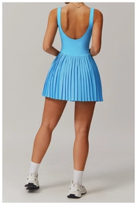 Detail of royal blue tennis dress featuring a deep U-back design and pleated hemline