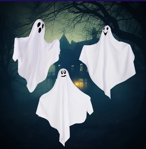 Detailed view of three hanging white ghosts with different facial expressions for Halloween
