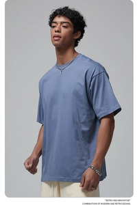 Detail of blue cotton oversize t-shirt showing crew neck and dropped shoulder seams