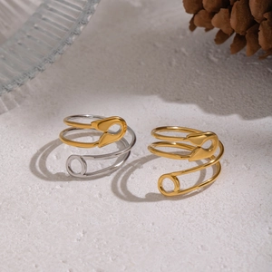 Detail of geometric paperclip open ring showing two-tone gold and silver metallic finish