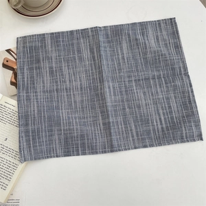 Macro detail of dark blue and white striped cotton linen placemat with woven texture