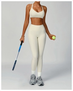 Detailed full body shot of high-waisted yoga pants and sports top in creamy white