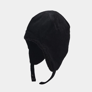 Detail of black corduroy trapper hat featuring soft faux shearling lining and chin strap