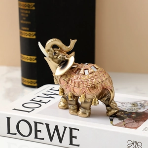 Detail of golden resin elephant figurine with colorful patterns and mirror inlay