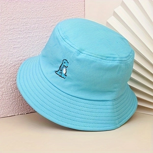 Detailed close-up of blue sun hat featuring a small embroidered dinosaur on cotton fabric