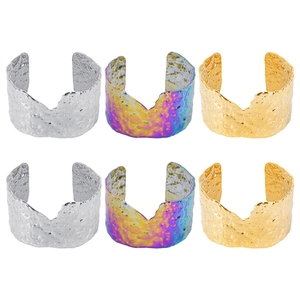 Detail of wide hammered texture cuff bracelets in gold, silver and rainbow finishes
