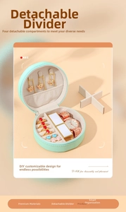 Detail of mint green round jewelry box with removable dividers and ring slots
