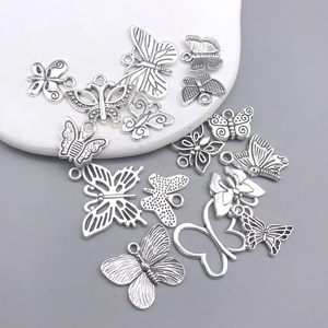 Detailed view of assorted silver tibetan alloy butterfly charms for DIY jewelry making