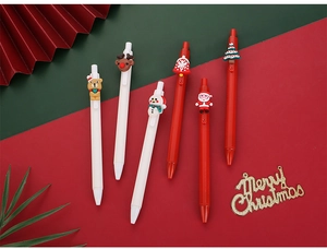 Festive Christmas pens featuring Santa, reindeer, and snowman toppers on a holiday background