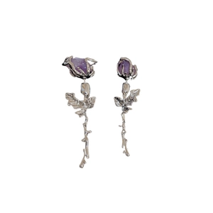Elegant rose drop earrings with purple crystals and silver floral stems on white background
