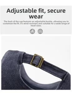 Detail of adjustable metal buckle and vintage washed fabric on a gray baseball cap