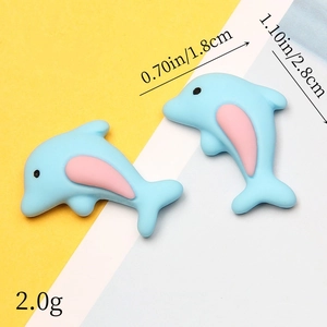 Macro detail of blue resin dolphin charms showing 1.8cm x 2.8cm dimensions and 2.0g weight