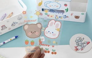 Close-up of cute cartoon waterproof stickers featuring animals and fruits in hand