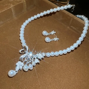 Close-up of bow knot pearl jewelry set with sparkling rhinestones in a velvet gift box