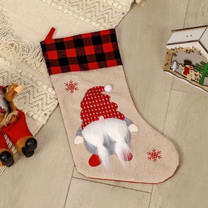 Nordic Christmas gnome stocking with red plaid cuff and burlap body for holiday decoration