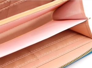 Close-up of long wallet interior with card slots, pink lining and metal zipper detail