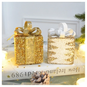 Detail of glitter gift box ornaments with ribbon bows for Christmas tree decoration