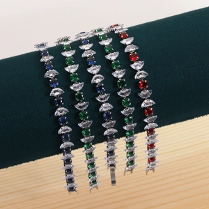 Colorful zircon bracelets displayed on green velvet rod with silver chain details