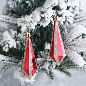 Adornos navideños de rayas rojas y doradas colgados en un árbol de Navidad nevado