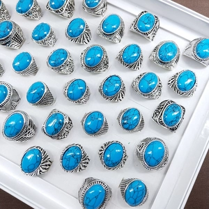 Vintage alloy rings with turquoise stones in assorted retro styles on a display tray
