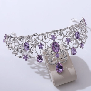 Close-up of bridal tiara with purple crystals and sparkling rhinestones in silver metal