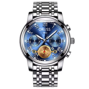 Close-up of the silver steel watch with a deep blue dial and double date display