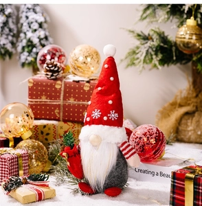Detail of Christmas gnome with snowflake embroidery, pearls and festive decor backdrop