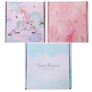 Three decorative paper gift boxes with unicorn and geometric patterns for hair accessories