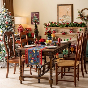 Christmas tree pattern navy table runner with tassels in a warm festive dining room