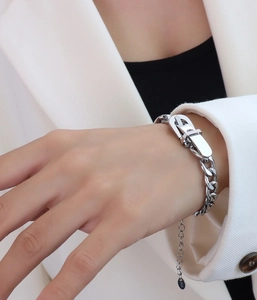 Detailed macro view of silver watch-buckle chain bracelet with K18 metal engraving mark