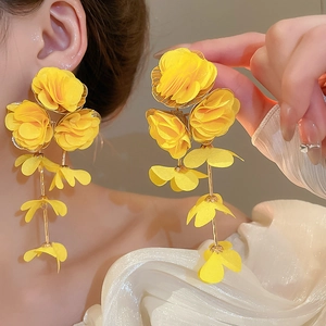 Detailed view of handmade yellow chiffon floral tassel earrings with flowing fabric petals