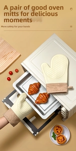 Detail view of silicone oven mitts with non-slip diamond texture and fabric cuff hanging loop