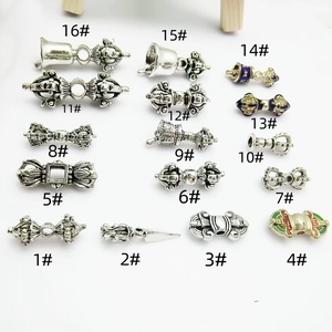 Collection of Tibetan silver vajra pestle bell charms for DIY Buddhist jewelry making