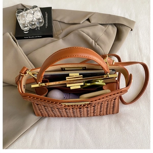 Interior view of brown woven handbag showing capacity for tablet, umbrella and cosmetics