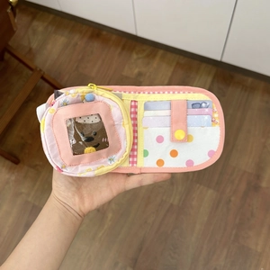 Detail of fabric wallet interior with card slots, transparent window and floral patterns