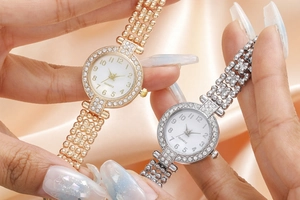 Detailed close-up of gold and silver rhinestone-studded quartz watches on silk cloth