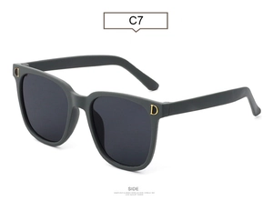 Detail of matte dark grey sunglasses with gold D logo and square fashion frames